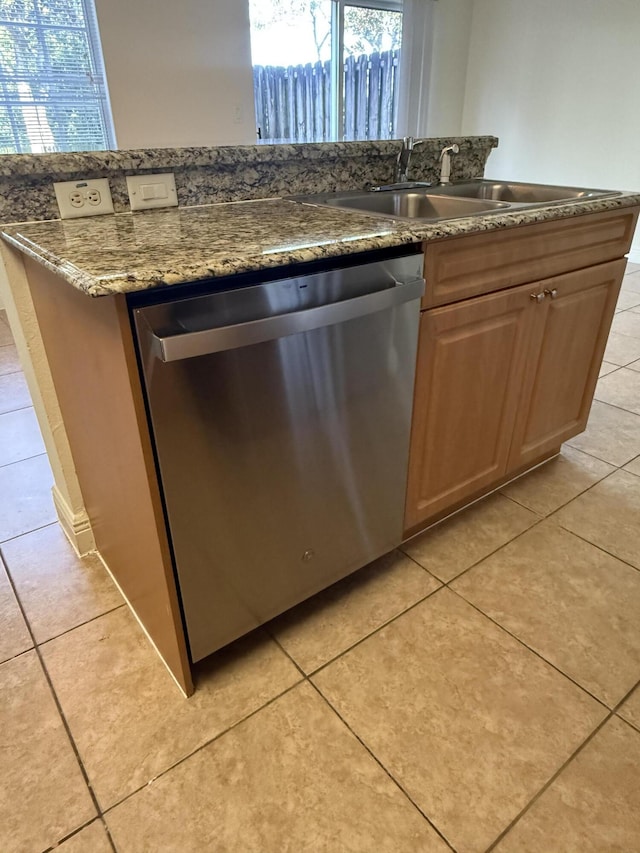 kitchen featuring sink, stainless steel dishwasher, and light tile patterned floors