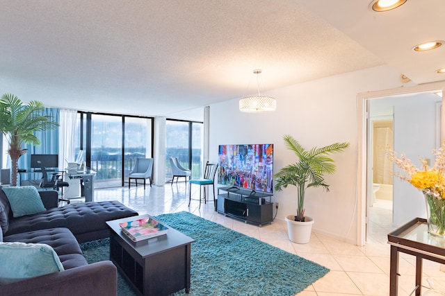 living room featuring expansive windows, an inviting chandelier, light tile patterned flooring, and a textured ceiling