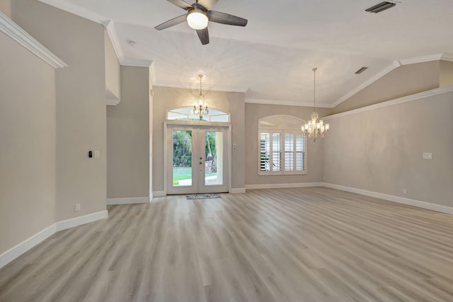 unfurnished room featuring french doors, ceiling fan with notable chandelier, vaulted ceiling, ornamental molding, and light hardwood / wood-style floors