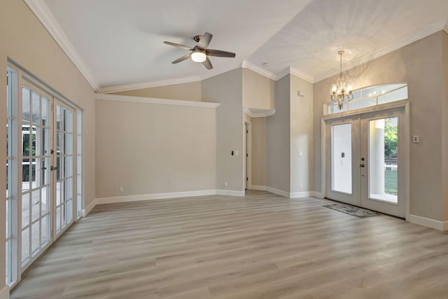 foyer entrance featuring french doors, light hardwood / wood-style flooring, lofted ceiling, ceiling fan with notable chandelier, and ornamental molding