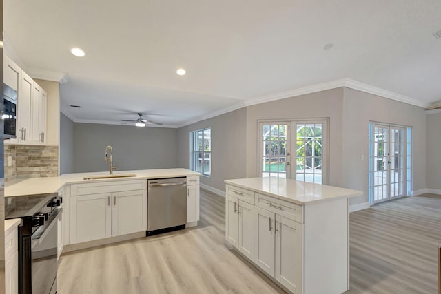 kitchen with white cabinets, sink, kitchen peninsula, and stainless steel appliances