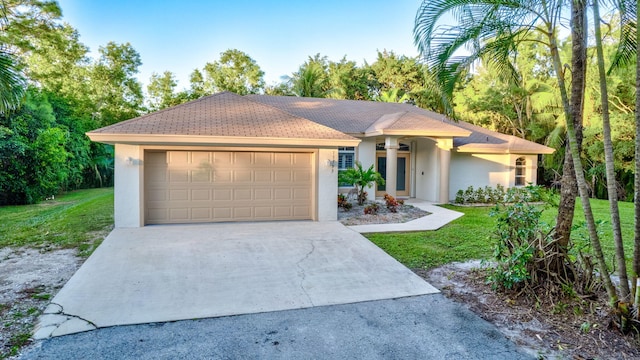 view of front of home featuring a garage and a front lawn