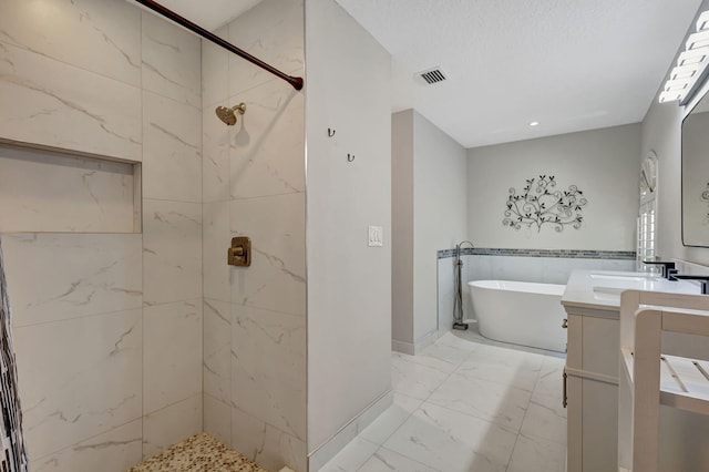 bathroom with plus walk in shower, a textured ceiling, and vanity