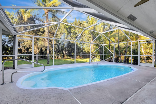 view of swimming pool with a lawn, a lanai, and a patio