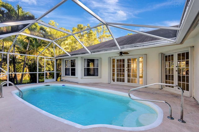 view of swimming pool featuring french doors, a patio, ceiling fan, and a lanai