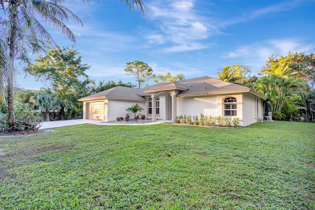 view of front of house featuring a front yard and a garage