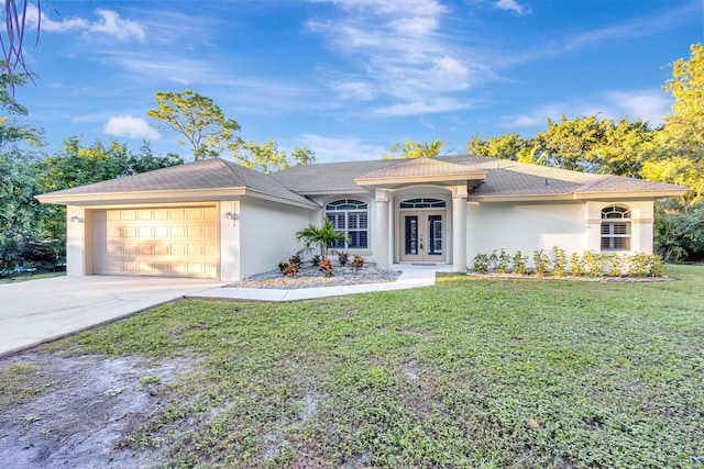 view of front of house featuring french doors, a garage, and a front lawn