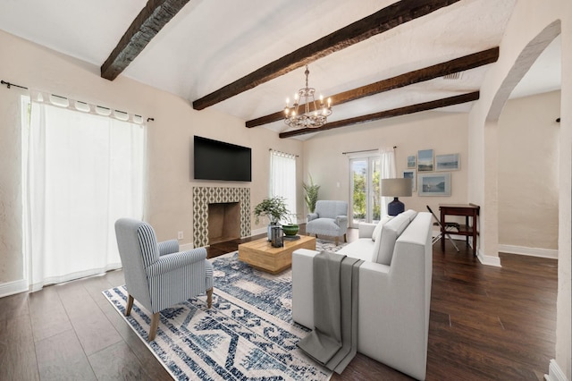 living room featuring a fireplace, beamed ceiling, dark wood-type flooring, and a chandelier