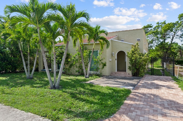 mediterranean / spanish house with a front lawn