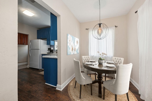 dining room with dark hardwood / wood-style flooring