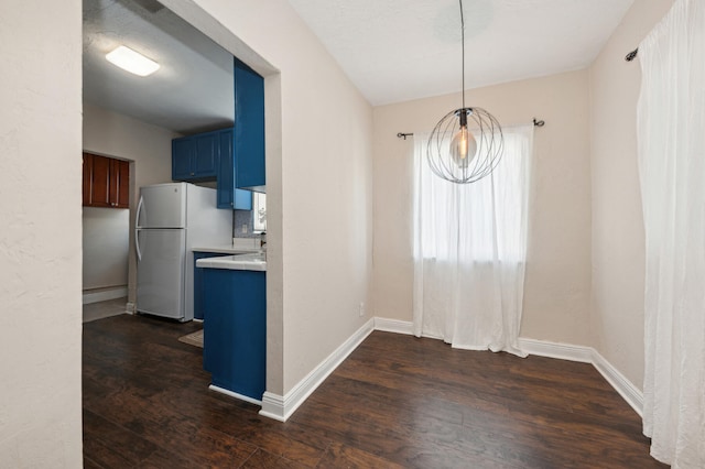 unfurnished dining area featuring dark wood-type flooring