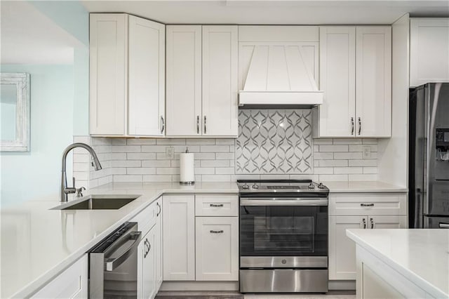 kitchen with custom range hood, stainless steel appliances, white cabinets, and backsplash