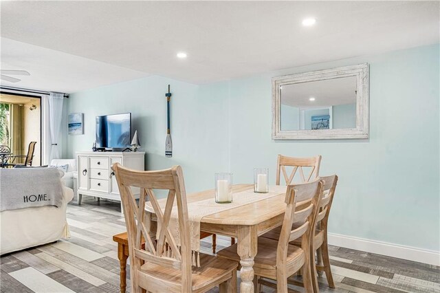 dining area with ceiling fan and light wood-type flooring