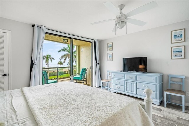 bedroom featuring light hardwood / wood-style flooring, ceiling fan, and access to outside