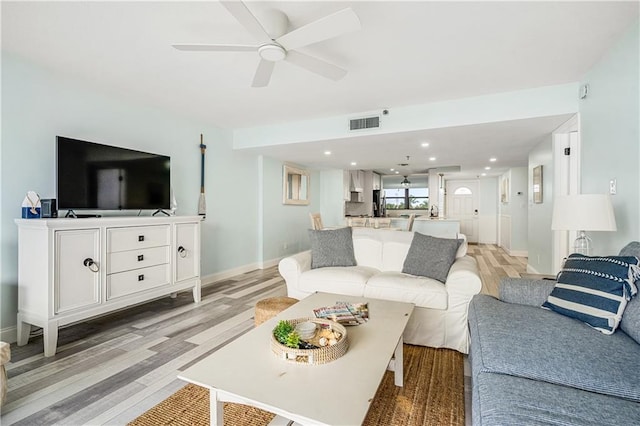 living room with ceiling fan and light hardwood / wood-style floors