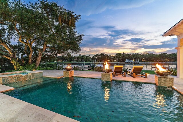 13209 Rolling Green Rd, North Palm Beach, FL 33408 - view of pool with a fire pit, a pool with connected hot tub, and a patio
