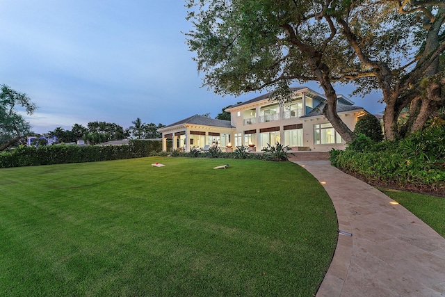 13209 Rolling Green Rd, North Palm Beach, FL 33408 - mediterranean / spanish-style home with a front yard and a balcony