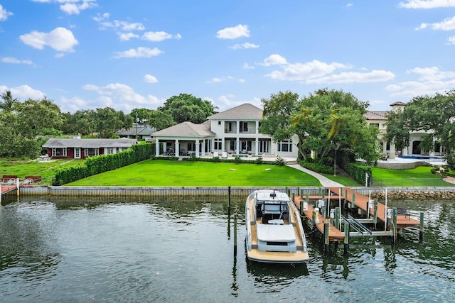 13209 Rolling Green Rd, North Palm Beach, FL 33408 - dock area with a water view, boat lift, and a yard