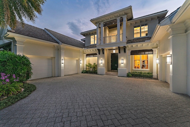 view of front of property with a garage and a balcony