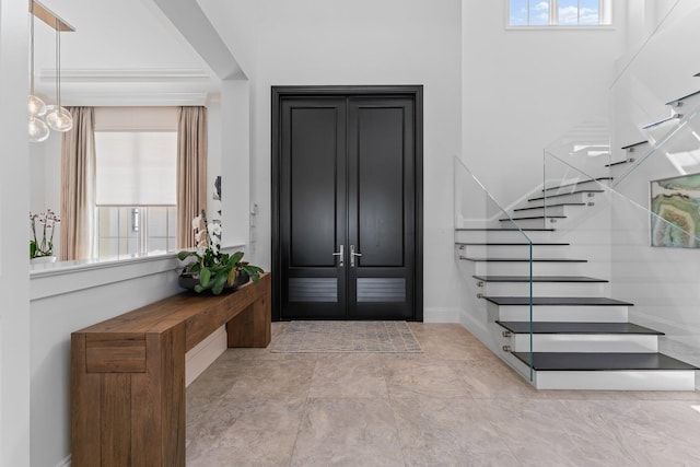 13209 Rolling Green Rd, North Palm Beach, FL 33408 - entryway featuring stairway and baseboards