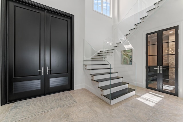 13209 Rolling Green Rd, North Palm Beach, FL 33408 - foyer with french doors, stairway, baseboards, and a towering ceiling
