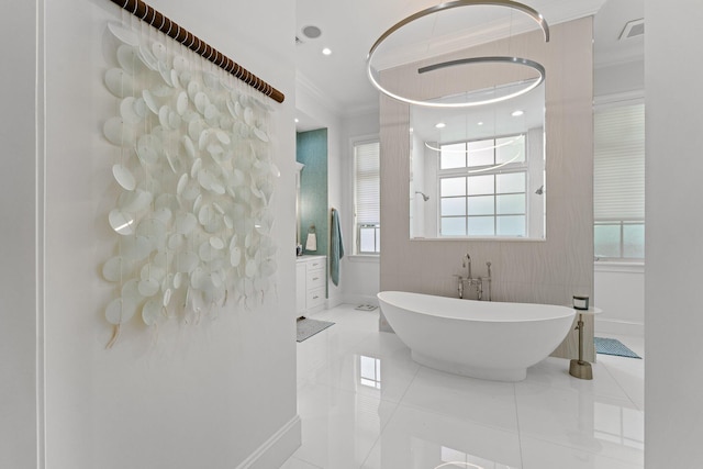 13209 Rolling Green Rd, North Palm Beach, FL 33408 - bathroom featuring crown molding, a freestanding tub, baseboards, vanity, and tile patterned floors