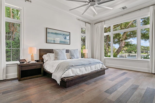 13209 Rolling Green Rd, North Palm Beach, FL 33408 - bedroom with multiple windows, ornamental molding, baseboards, hardwood / wood-style flooring, and a water view