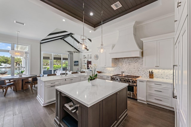 13209 Rolling Green Rd, North Palm Beach, FL 33408 - kitchen featuring double oven range, a peninsula, a sink, custom exhaust hood, and a chandelier