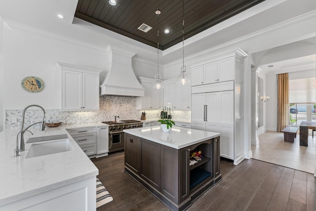 13209 Rolling Green Rd, North Palm Beach, FL 33408 - kitchen featuring double oven range, premium range hood, a sink, a raised ceiling, and white cabinetry