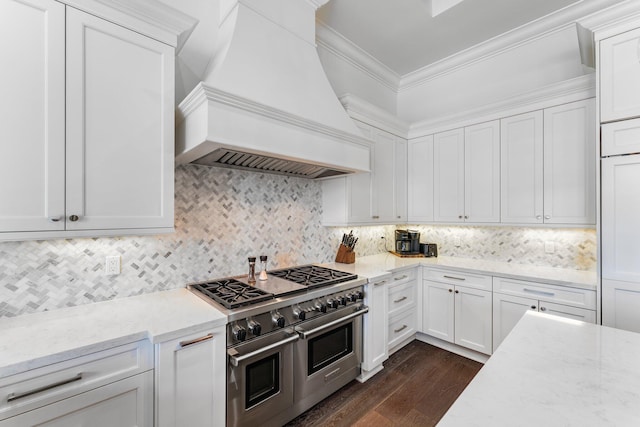 13209 Rolling Green Rd, North Palm Beach, FL 33408 - kitchen featuring range with two ovens, premium range hood, ornamental molding, dark wood-style flooring, and white cabinets