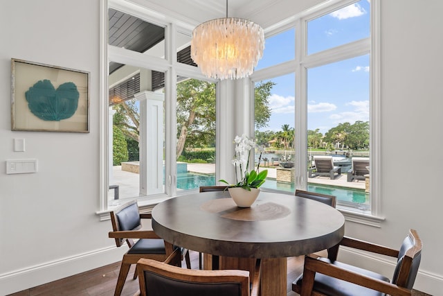 13209 Rolling Green Rd, North Palm Beach, FL 33408 - dining area featuring wood finished floors, a chandelier, and baseboards