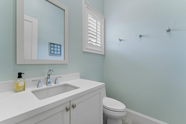 13209 Rolling Green Rd, North Palm Beach, FL 33408 - bathroom featuring toilet, vanity, and baseboards
