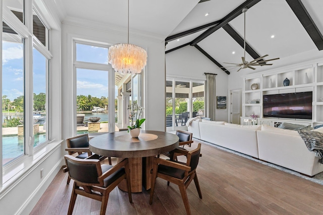 dining area with hardwood / wood-style flooring, a healthy amount of sunlight, and high vaulted ceiling