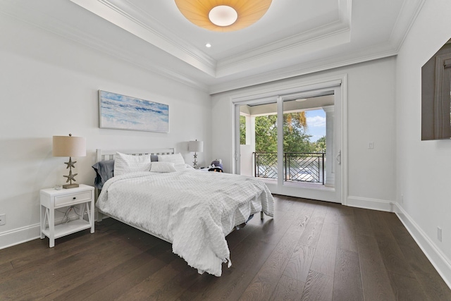 bedroom featuring crown molding, dark hardwood / wood-style floors, access to exterior, and a tray ceiling