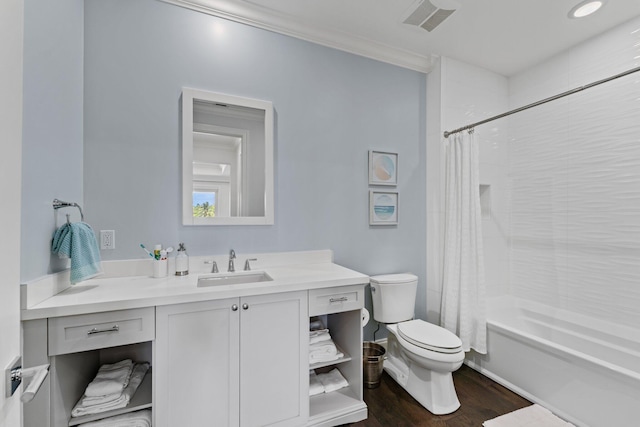 full bathroom with hardwood / wood-style flooring, toilet, crown molding, shower / tub combo with curtain, and vanity