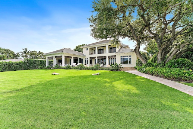 13209 Rolling Green Rd, North Palm Beach, FL 33408 - view of front facade with a front yard and covered porch