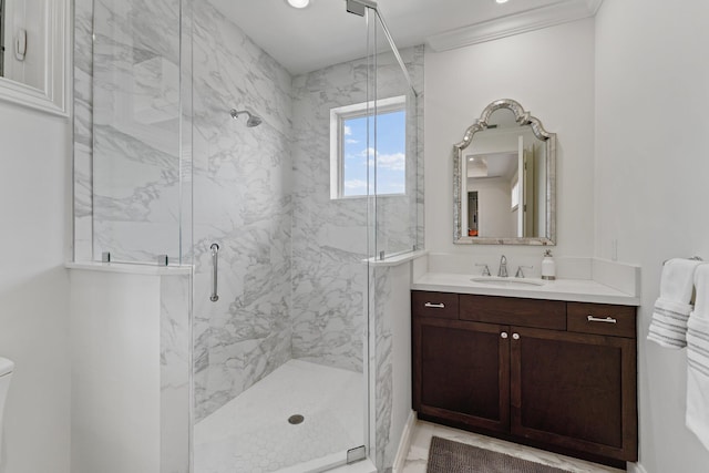 bathroom with vanity, ornamental molding, and an enclosed shower