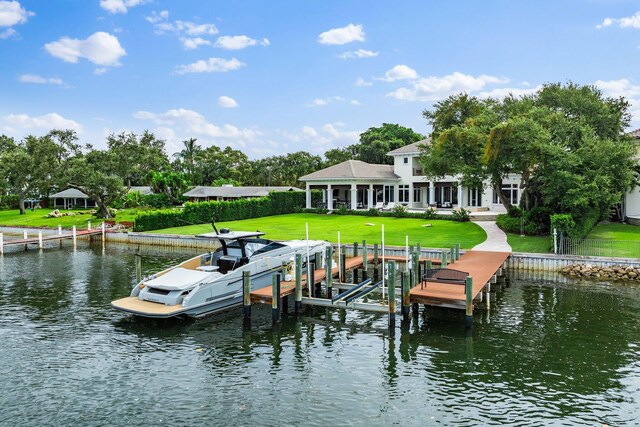 13209 Rolling Green Rd, North Palm Beach, FL 33408 - dock with boat lift, a water view, and a yard