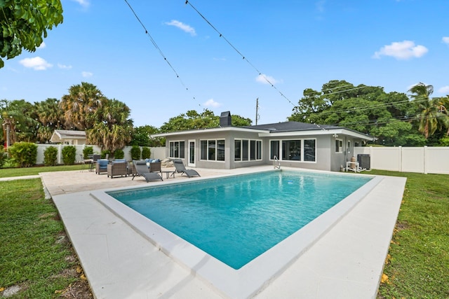 view of swimming pool with a patio area, an outdoor hangout area, and a lawn