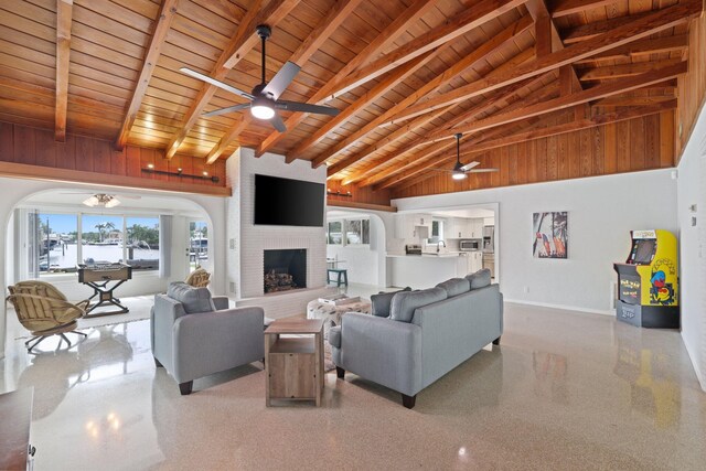 living room with ceiling fan, a fireplace, high vaulted ceiling, and wood ceiling