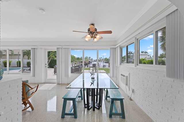 sunroom / solarium featuring a wealth of natural light and ceiling fan