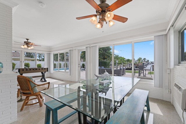 sunroom / solarium featuring radiator heating unit and ceiling fan