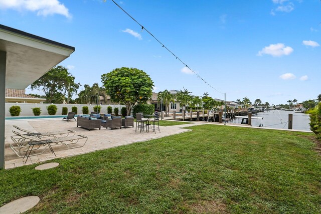 view of yard featuring a fenced in pool, outdoor lounge area, and a patio area