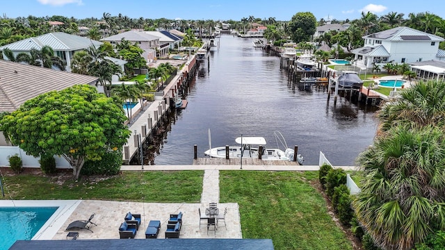 view of dock featuring a patio area, a water view, and a fenced in pool