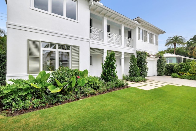 view of front of property with a garage and a front lawn