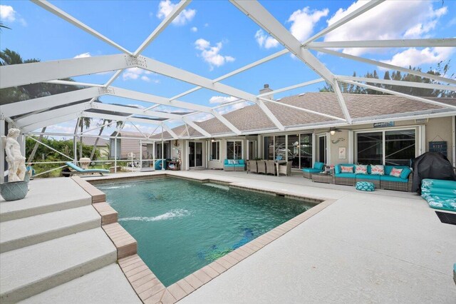 view of swimming pool with glass enclosure, an outdoor living space, and a patio area