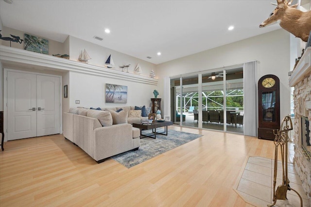 living room with light hardwood / wood-style floors and a fireplace