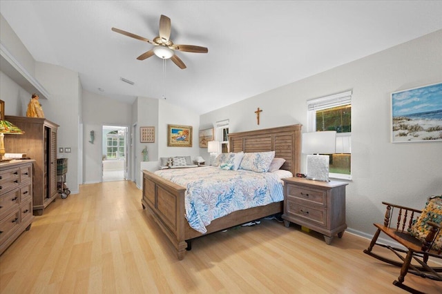 bedroom with ceiling fan, light hardwood / wood-style floors, and vaulted ceiling