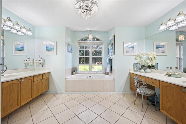 bathroom featuring tiled bath, vanity, and tile patterned floors