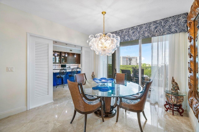 tiled dining room with a notable chandelier